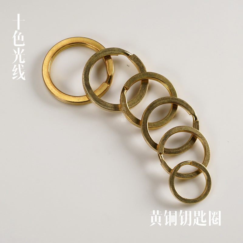 Solid brass key rings linked together, five round loops in a row