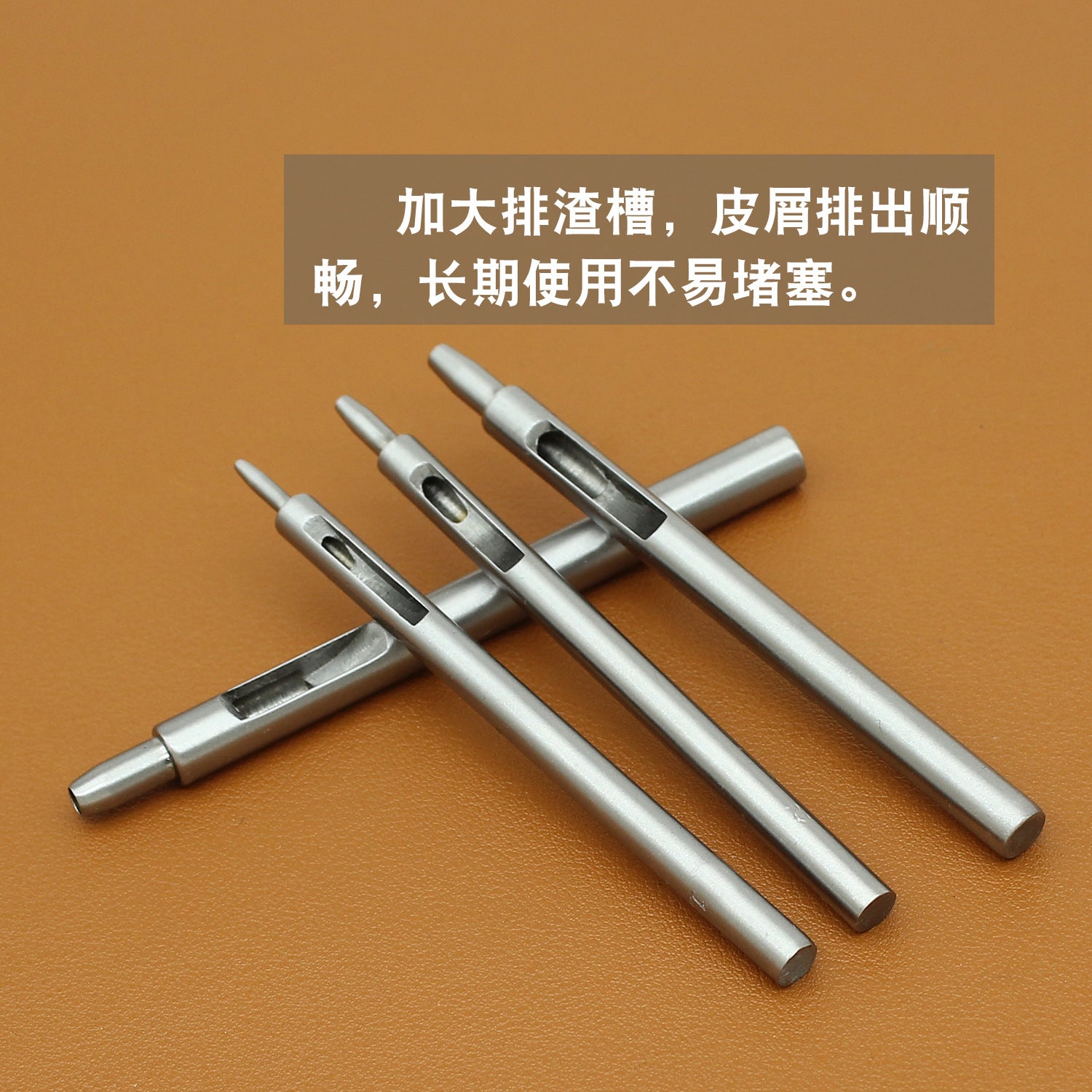 Assorted round leather hole punch tools, silver hollow punches laid out