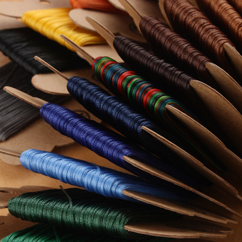 Waxed polyester thread spools with tightly wound strands in blue, green, and brown