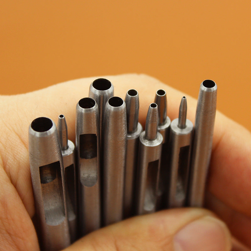 Round hole punch tool set with multiple silver cylindrical punch bits