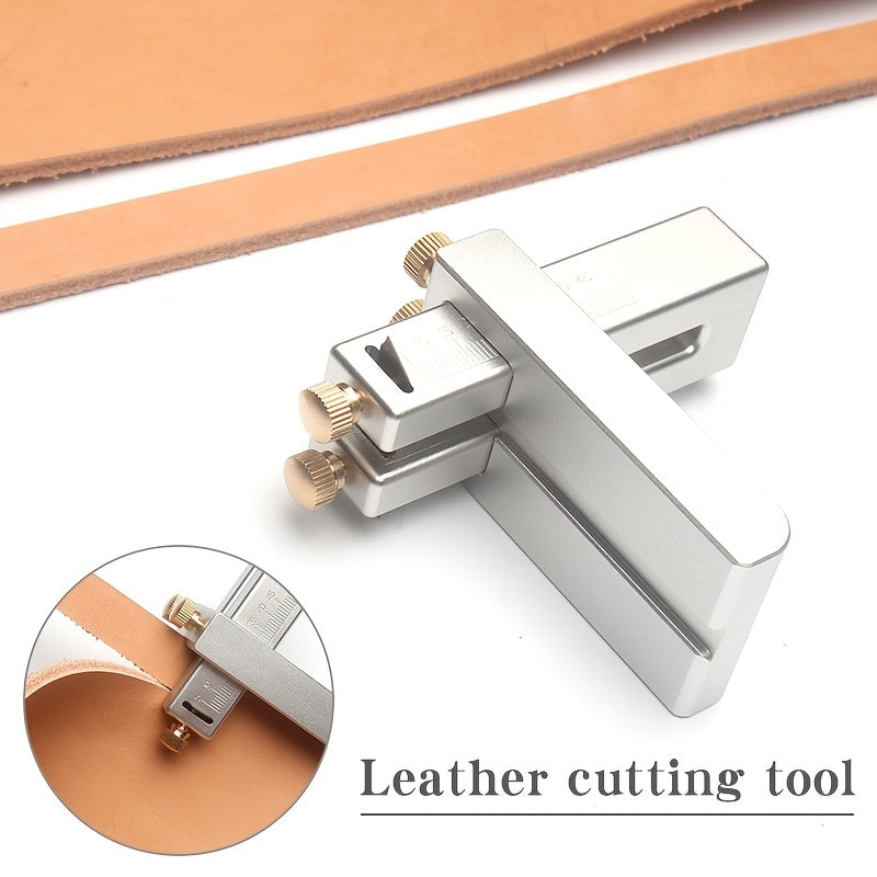 Aluminum leather strap cutting tool with blade engaged on leather strip, brass knobs