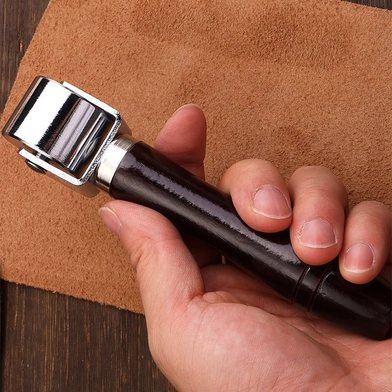 Leather roller press with dark wood handle and chrome metal roller