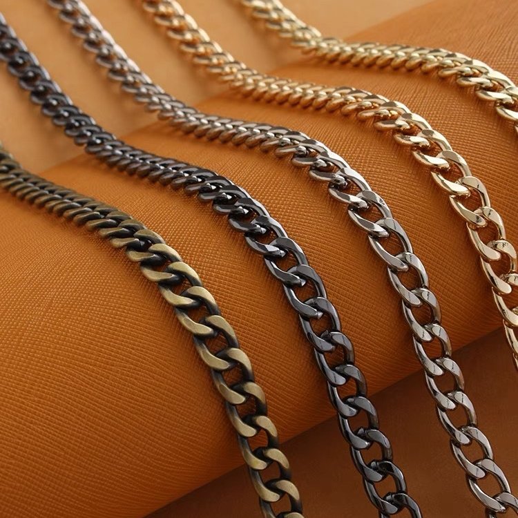 Metal bag chain strap close-up, braided twisted chain links in multiple metal tones