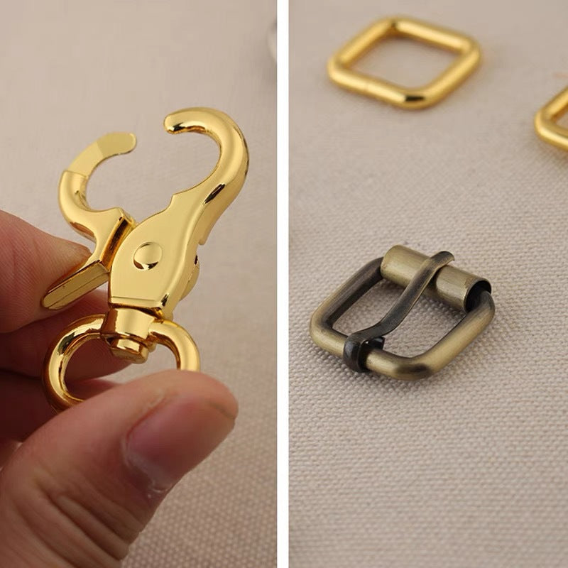 Bag hardware set detail: gold swivel hook and metal roller buckle