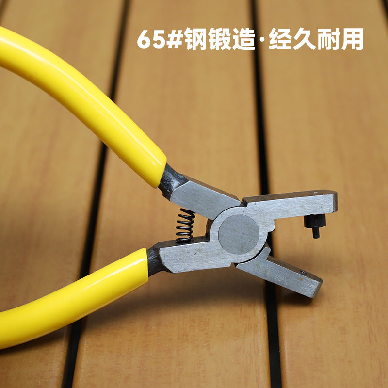 Mini hole punch pliers close-up: yellow handles with metal punch and spring