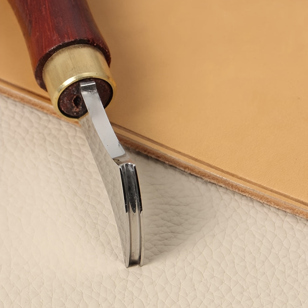 Leather edge creaser tool with metal V blade and wooden handle forming a leather crease