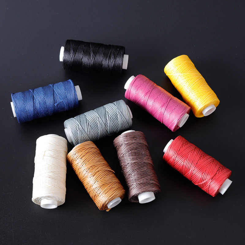 Waxed leather stitching thread spools in multiple colors: black, blue, pink, yellow, red
