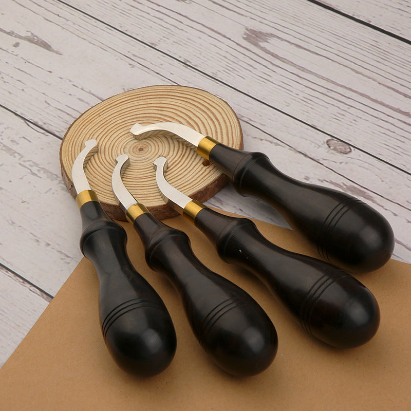 Leather edge creaser tools with dark handles and gold bands, plus metal curved tips