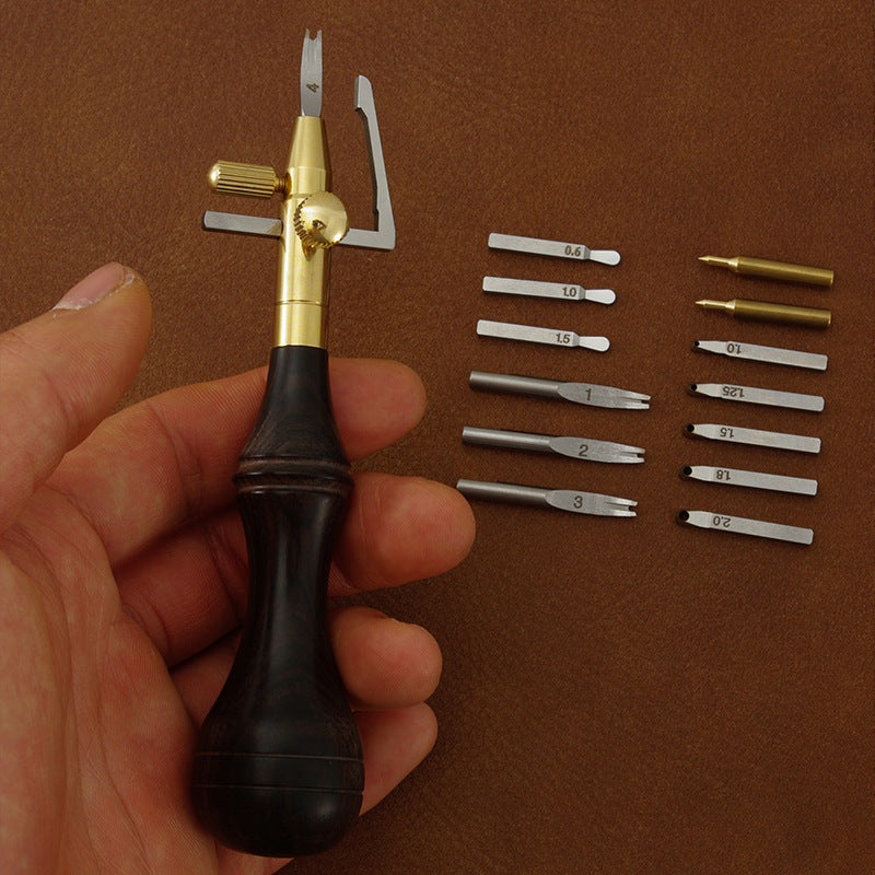 Leather edge cutter handle held by hand with assorted trenching heads