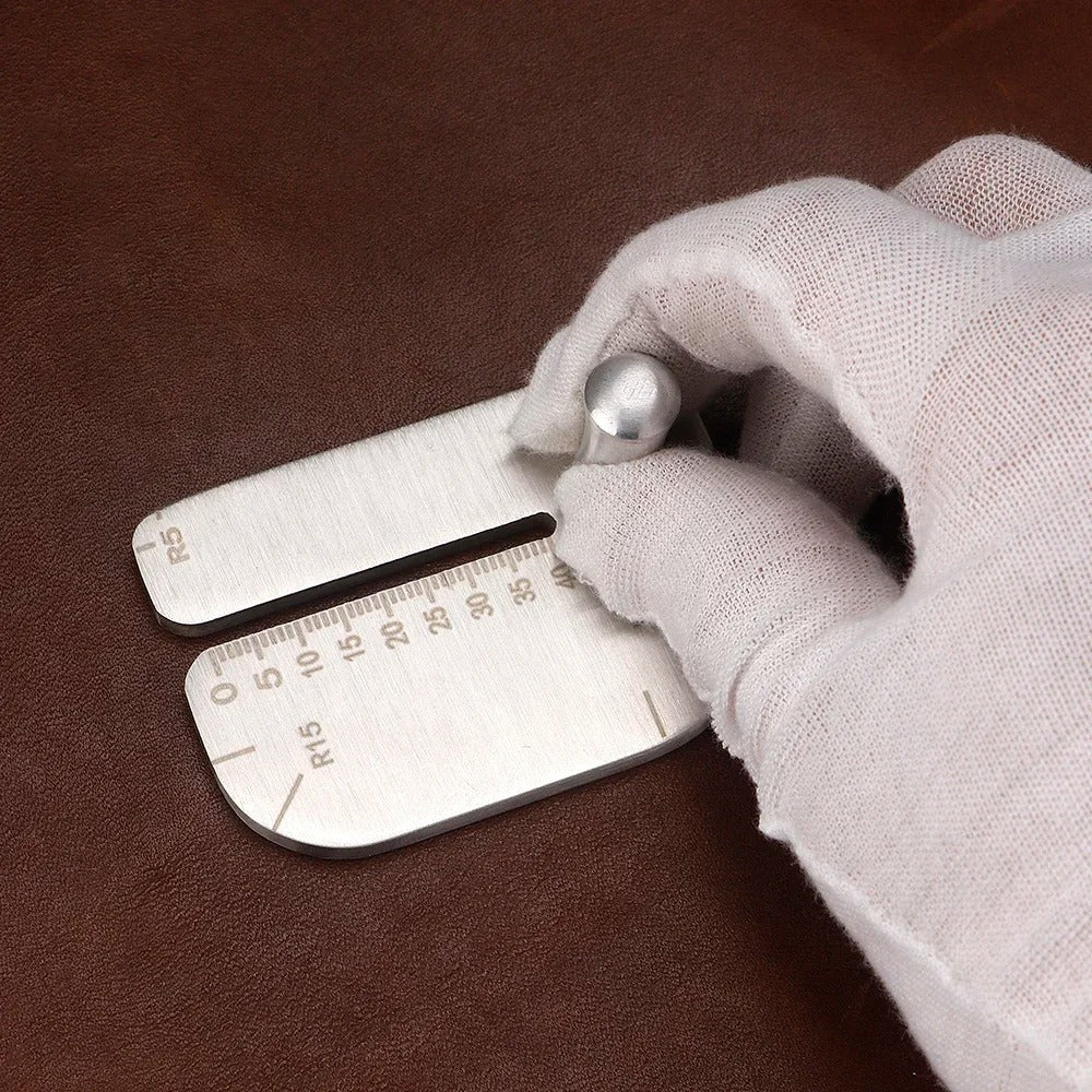 Leather stitching punch guide being held against leather by a gloved hand