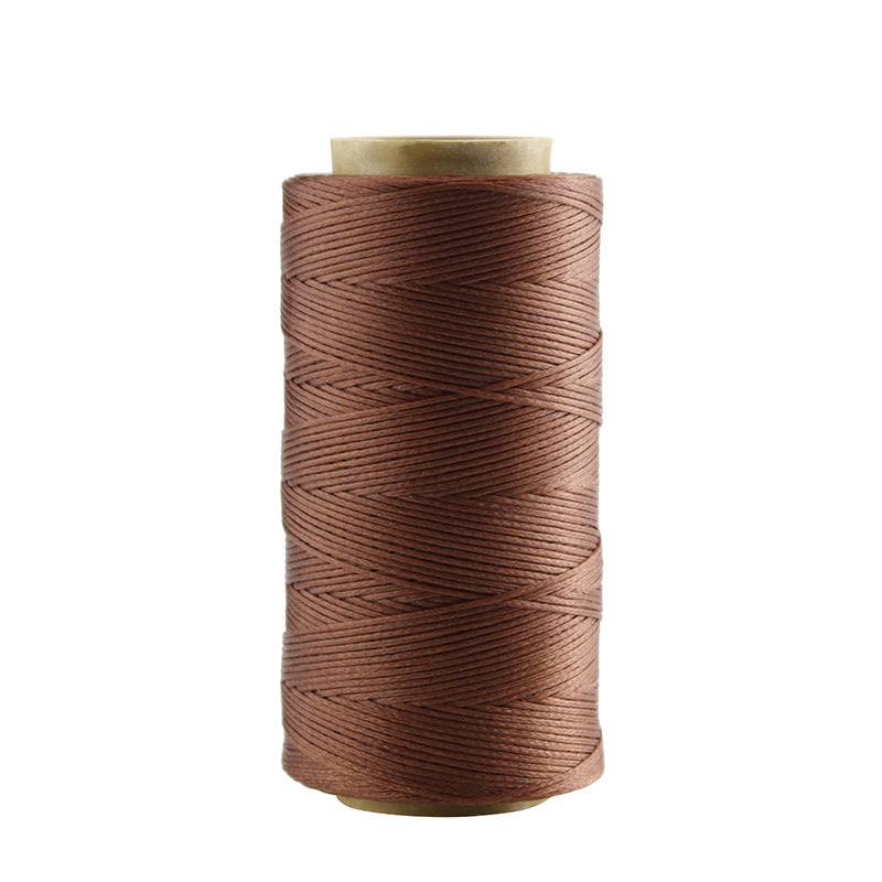 Brown waxed polyester stitching thread spool