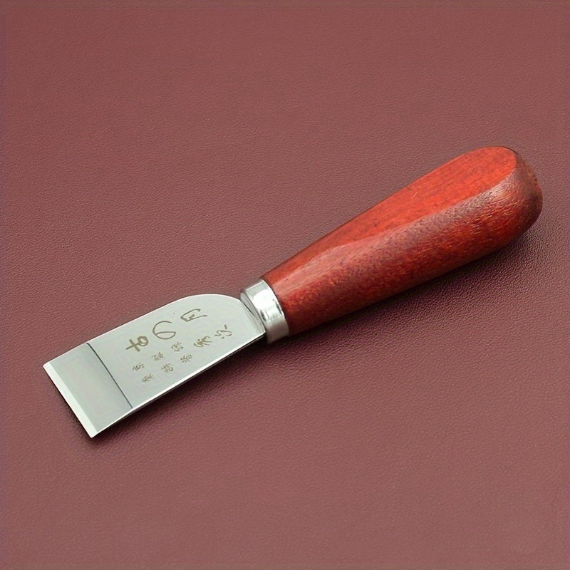Leather cutting knife with red wooden handle and flat steel blade