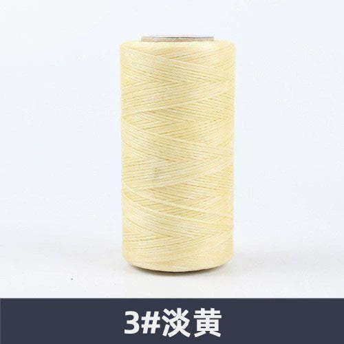 Light yellow waxed polyester sewing thread spool, flat 150D