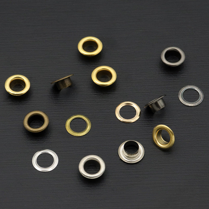 Assorted metal eyelet rings in gold, silver, and dark finishes