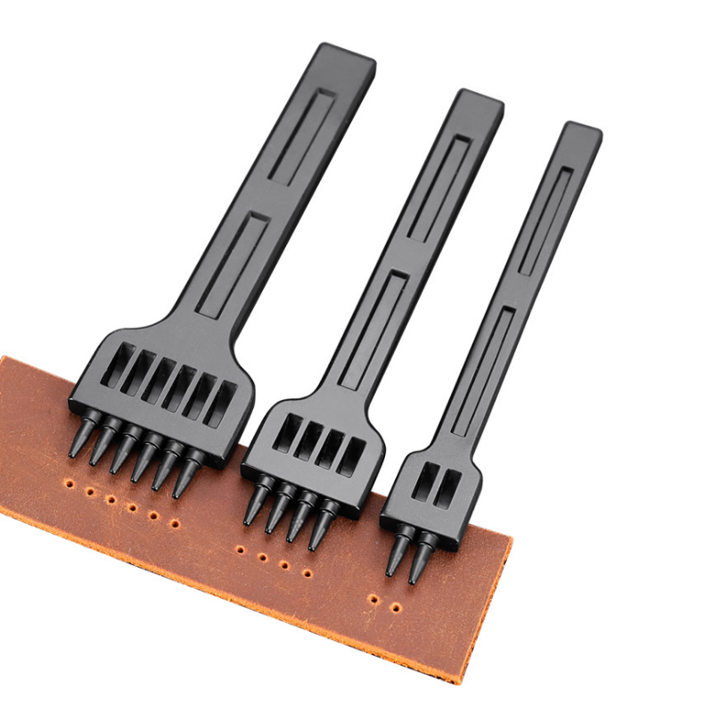 Set of black leather hole punches with row of pins on a brown leather strip