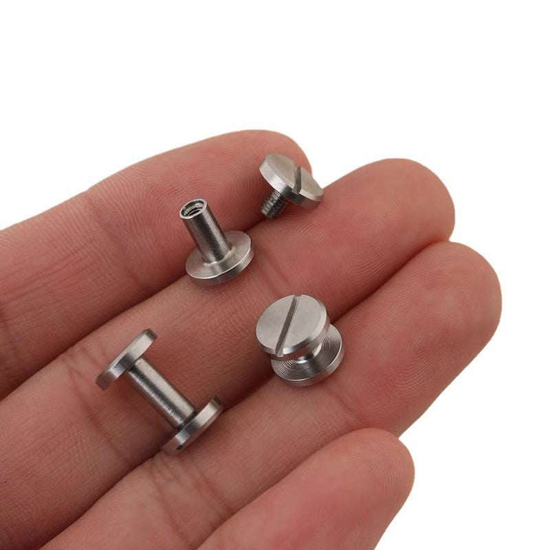 Stainless steel flat-head rivet screws in hand, visible threads and looped shaft