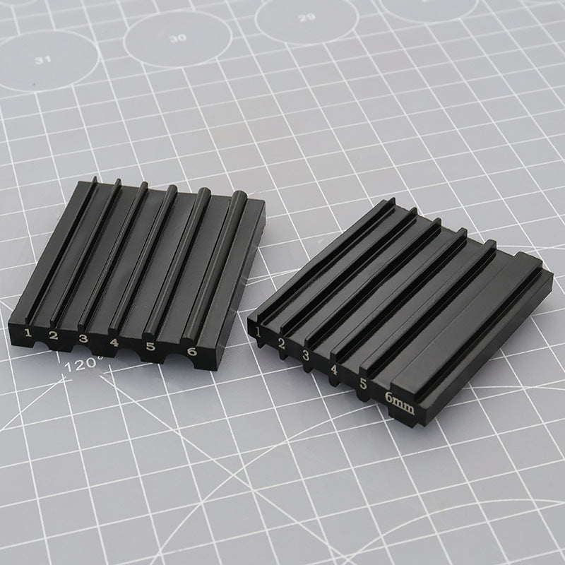 Two black knife sharpener inserts with numbered corners and 6mm groove marking