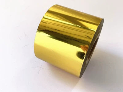 Hot stamping foil roll, curved glossy gold metallic with reflective sheen