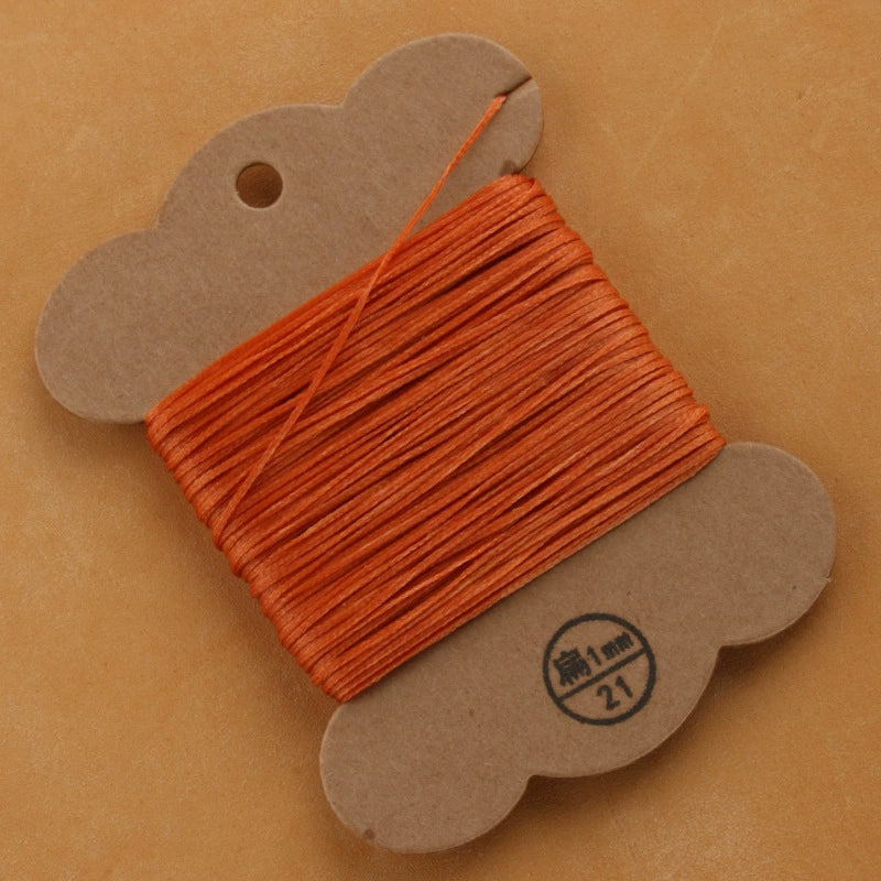 Flat waxed polyester thread spool, orange, 1mm on cardboard card