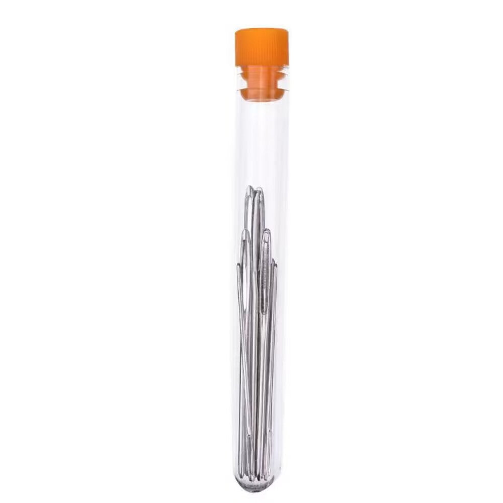 Blunt eye sewing needles in clear storage bottle with orange screw cap