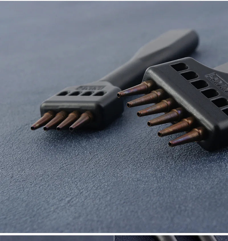 Black hole punching tools with copper prongs on flat surface