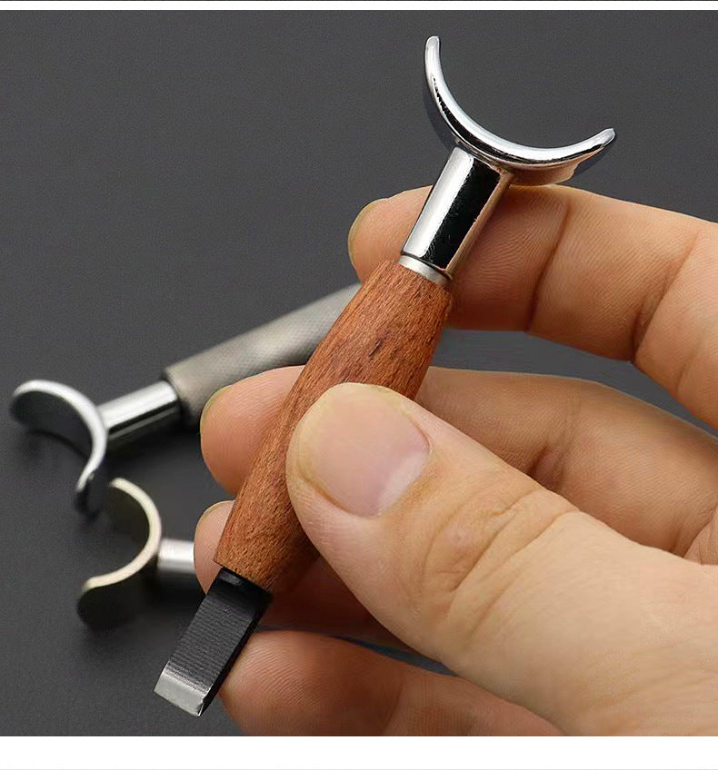 Swivel carving knife held in hand with rosewood handle and curved chrome yoke