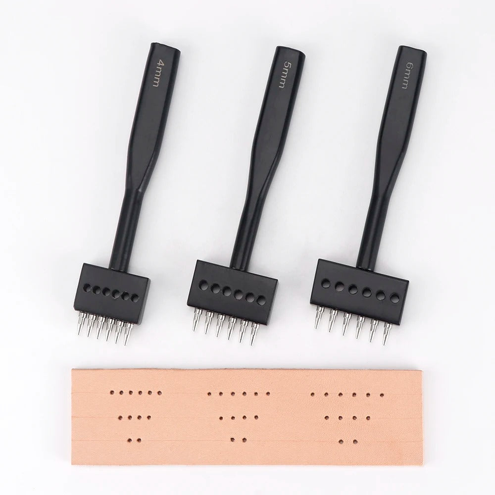 Three black leather hole punch tools with toothed heads and rows of metal pins
