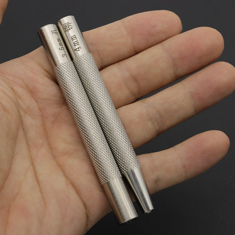 Two metal rivet setters in a hand, showing textured grip and silver tips