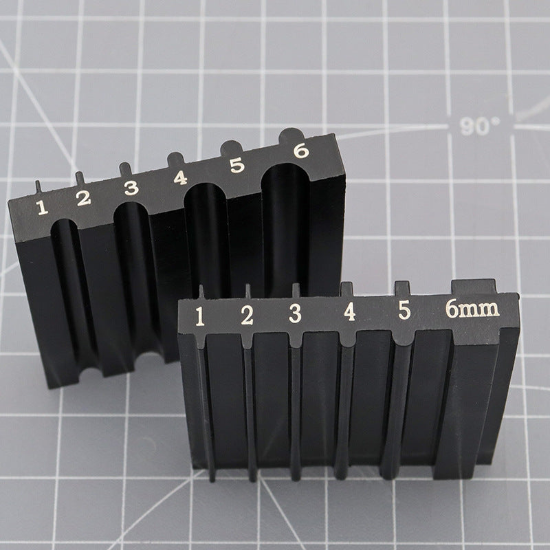 Black dual-sided knife sharpener and repair tool with numbered openings, 6mm mark