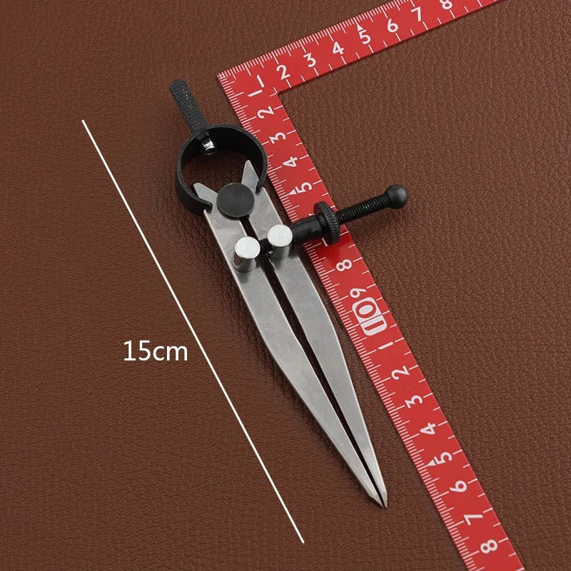 Wing divider tool with lockable adjustment, black clamp and silver legs beside measuring tape
