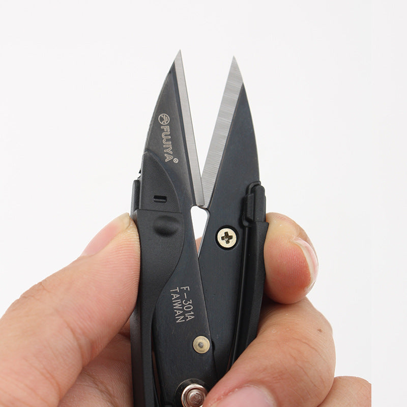 Spring thread snips with black handles and visible screws, held close in hands
