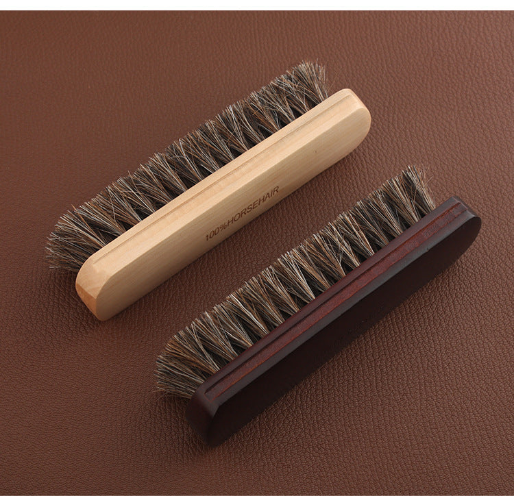 Two wooden-handled horsehair brushes with dark bristles, side by side