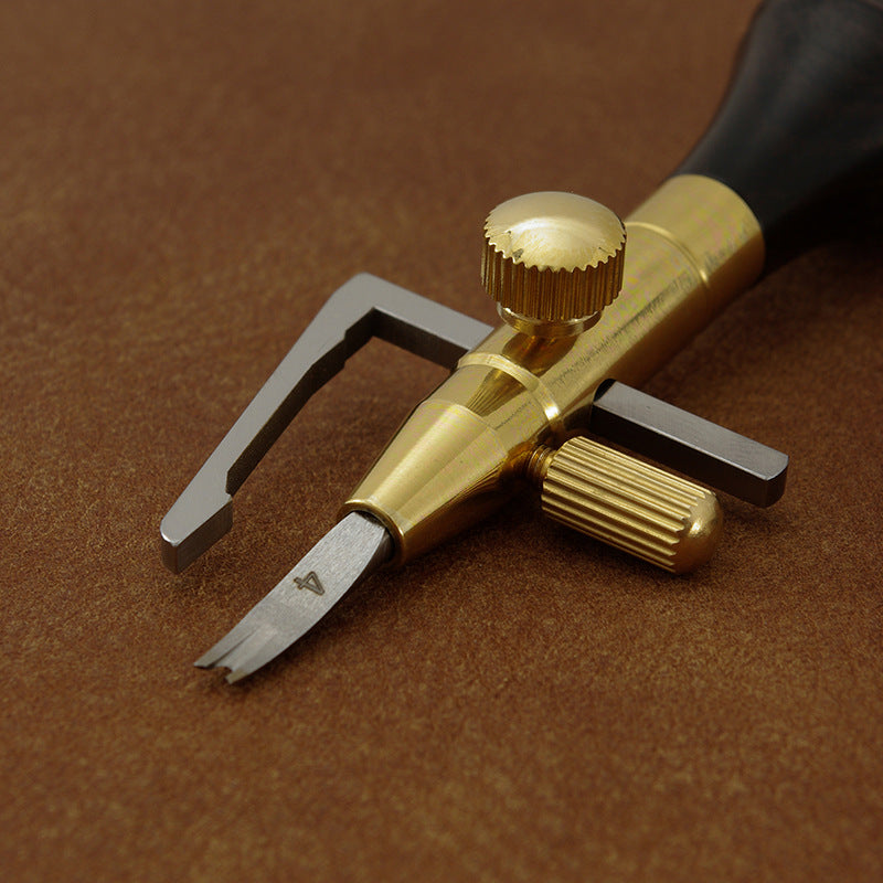 Leather edge cutter head close-up with gold adjustable knob and silver blade
