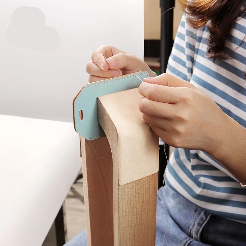 Beechwood stitching pony holding a light blue leather piece while tightening the clamp