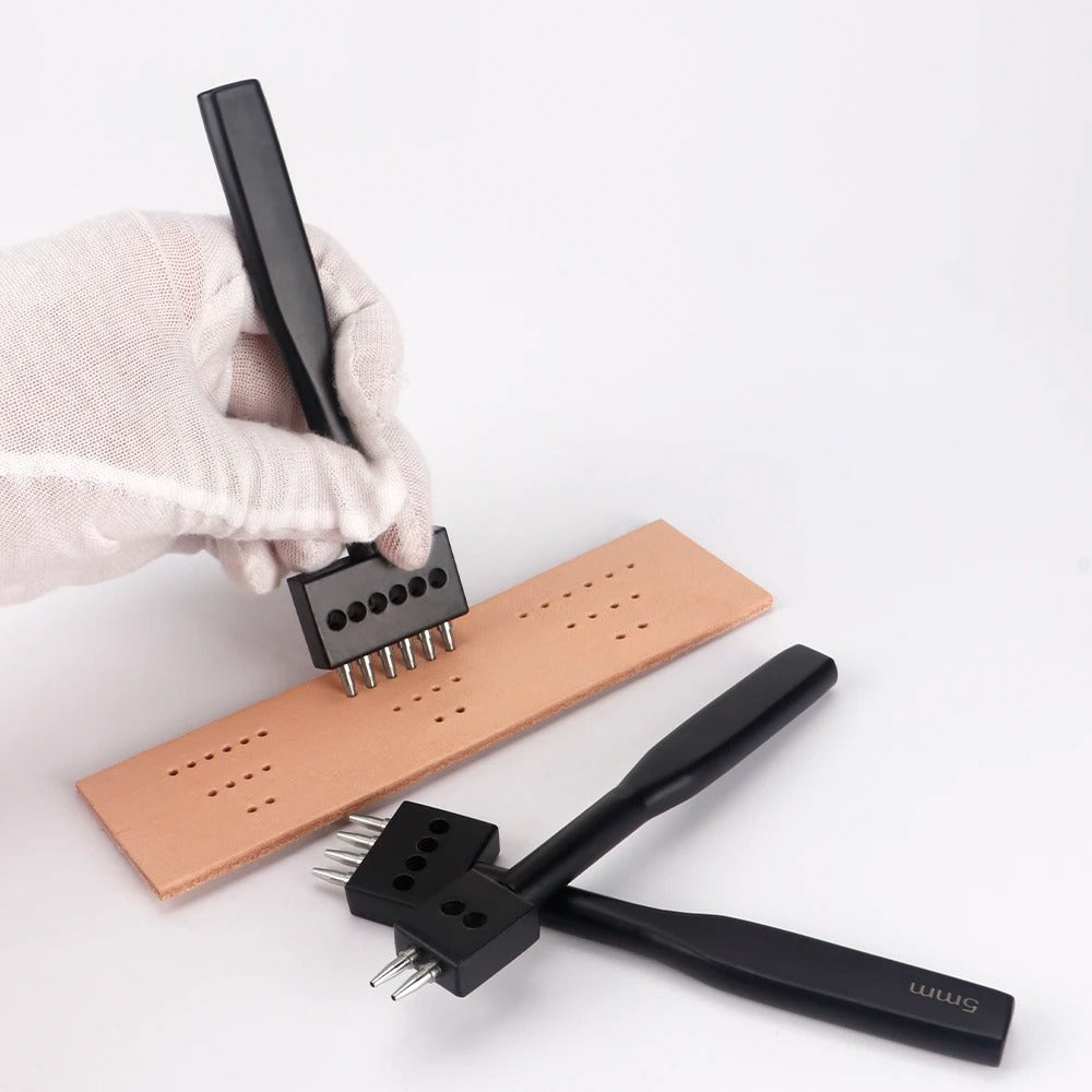 Leather hole punch tools creating stitched holes in a tan leather strip