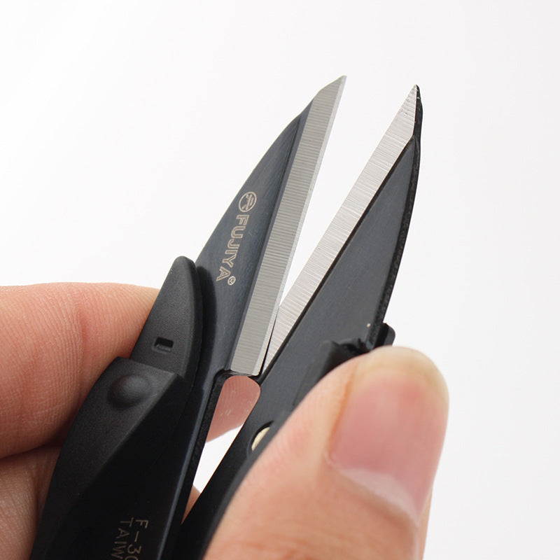 Black spring thread snips close-up of angled blades and finger grip