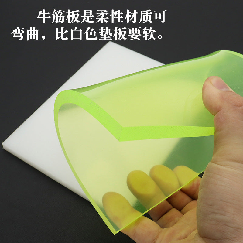 Green elastic punching pad board held in hand over white backing sheets
