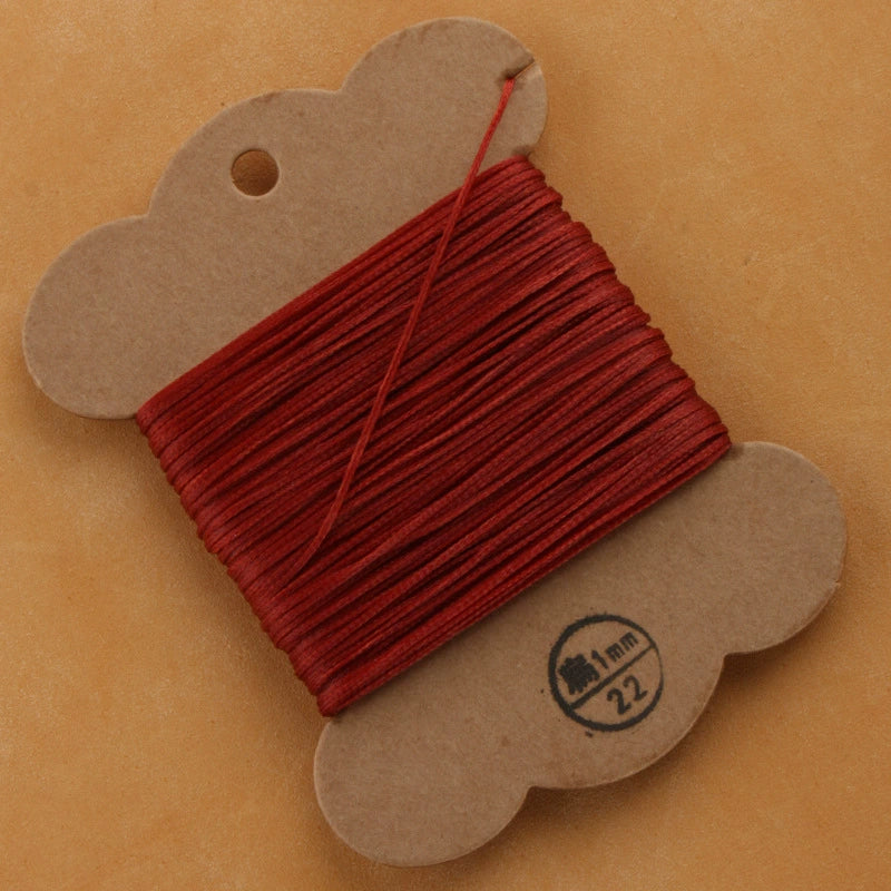 Flat waxed polyester thread spool, deep red, 1mm on cardboard card