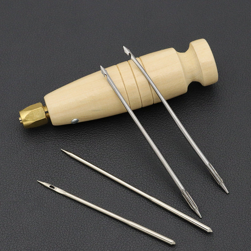 Wood-handled awl with multiple pointed steel needles laid out on dark surface