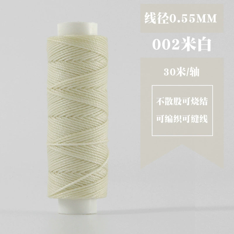 Off-white waxed round thread spool