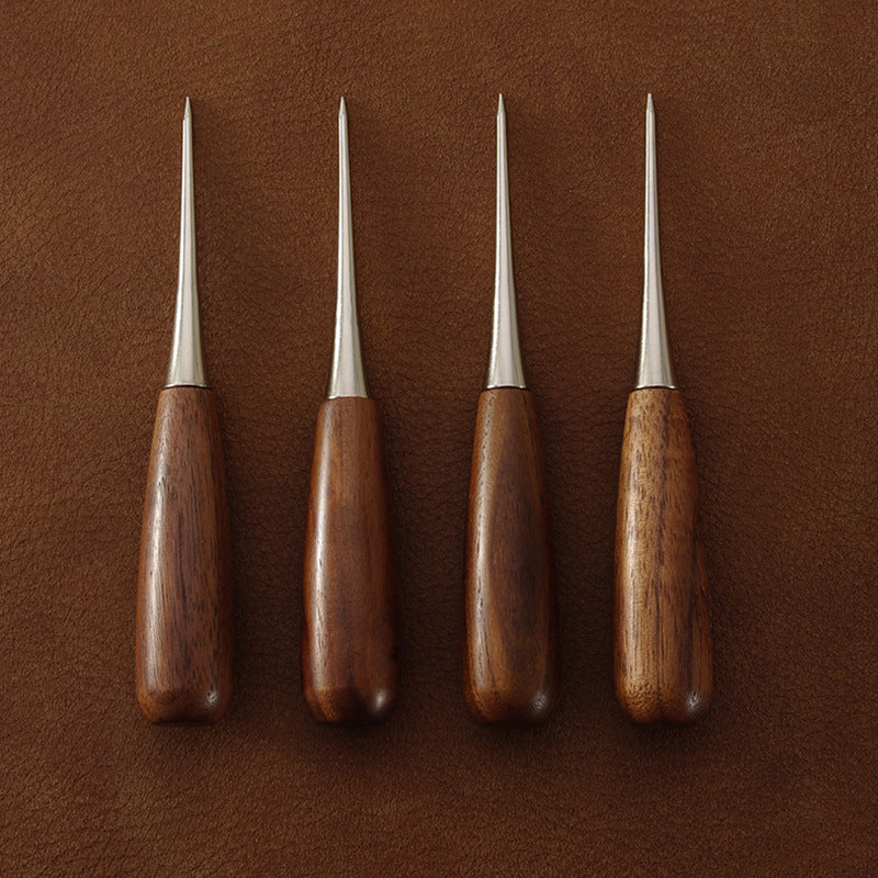 Four leather scratch awls with mixed wooden handle colors and pointed metal tips