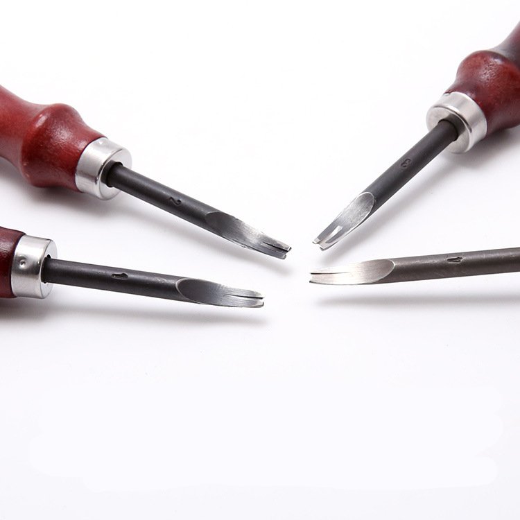 Leather edge beveler blades with red wooden handles and silver ferrules