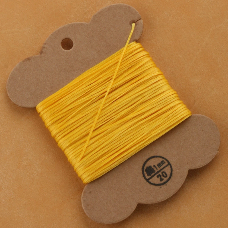 Flat waxed polyester thread spool, golden yellow, 1mm on cardboard card