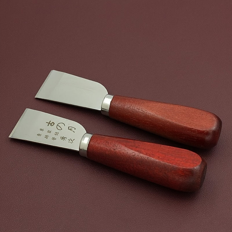 Two leather cutting knives with wooden handles and flat steel blades