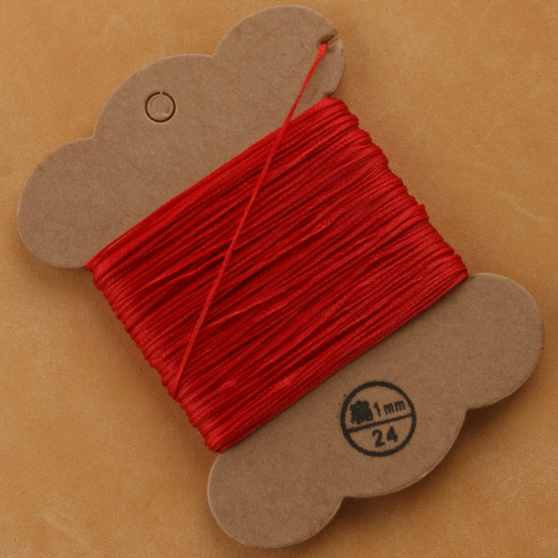 Flat waxed polyester thread spool, bright red, 1mm on cardboard card