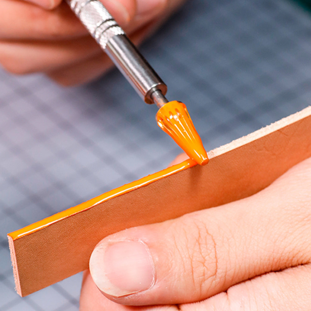 Leather edge oil pen applying orange oil along a leather edge