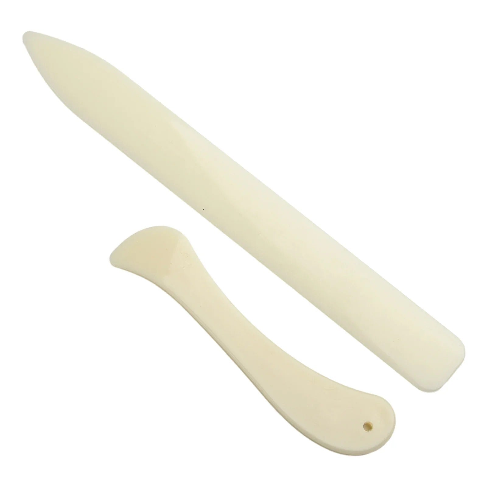 Cream leather bone folders, long curved tool and shorter rounded tool