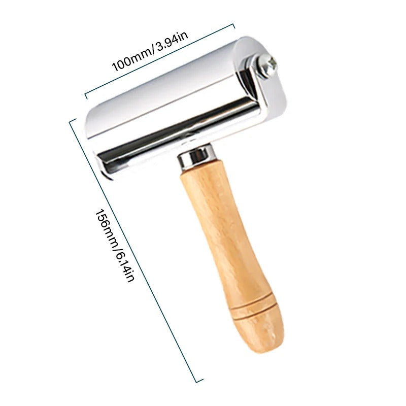 Leather roller press with 100mm chrome roller and light wood handle, 156mm