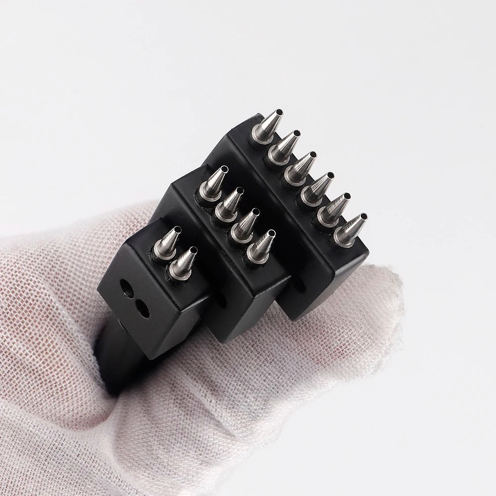Leather hole punch tool with black toothed head and metal prongs on fabric