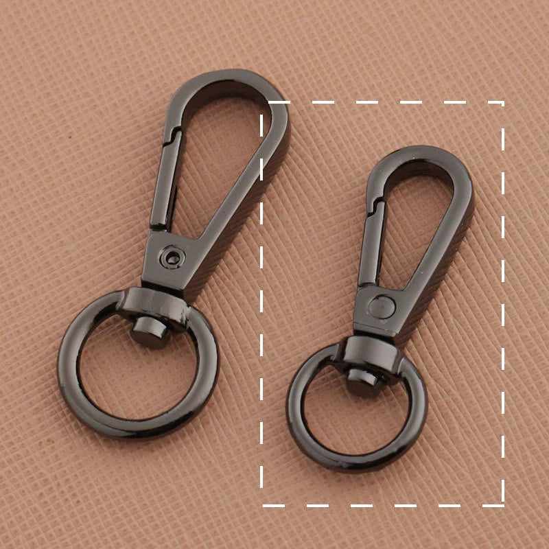 Swivel lobster claw hook buckle hardware, two dark gunmetal-tone metal hooks with rings